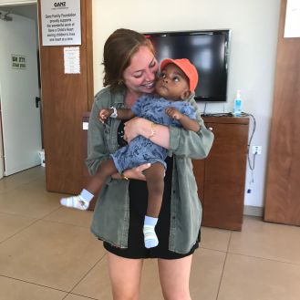 CNHP alumna Dara Engel holding an infant